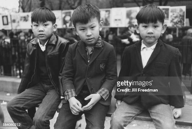Three boys sit for the camera in Chinatown, New York City, 1967.