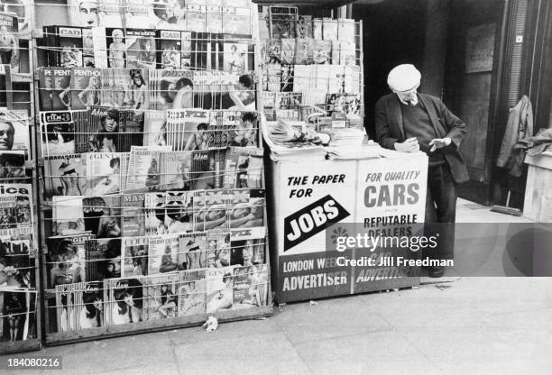 Vendor selling newspapers and pornographic magazines in London, 1969.