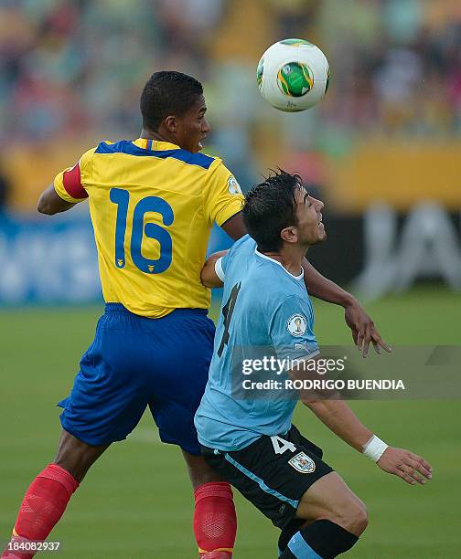Ecuadorean midfielder Antonio Valencia vies for the ball with Uruguayan Jorge Fucile during their Brazil 2014 FIFA World Cup South American qualifier...
