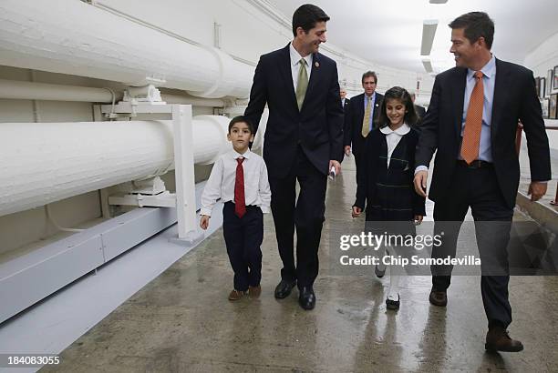 House Budget Committee Chairman Paul Ryan and Rep. Sean Duffy walk with Duffy's nephew and niece through the tunnel to the Longworth House Office...