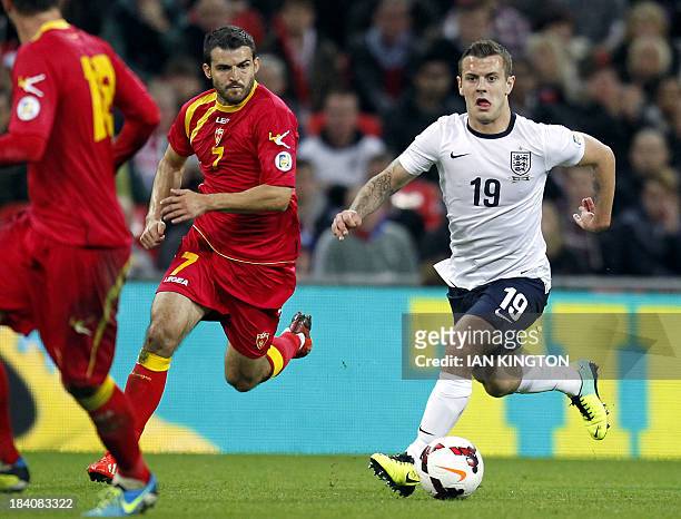 England's midfielder Jack Wilshere runs with the ball past Montenegro's midfielder Simon Vukcevic during the World Cup 2014 Group H Qualifying...