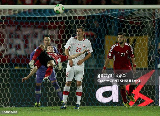 Albania's Hamdi Salihi jumps to shoot the ball during the FIFA 2014 World Cup qualifying football match between Albania and Switzerland on October...