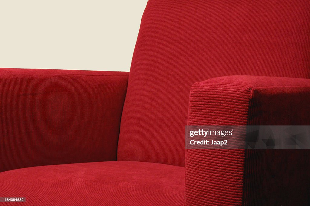 Modern red corduroy armchair, fragment with shallow DOF