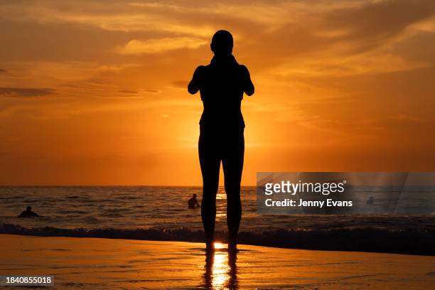 People watch the sunrise at Bondi Beach on December 09, 2023 in Sydney, Australia. A severe heat wave was predicted for the weekend, a precursor of...