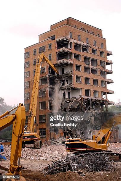 cranes demolishing a brick building - demolition stock pictures, royalty-free photos & images