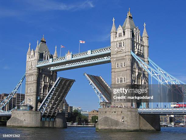 tower bridge rising - tower bridge stock-fotos und bilder