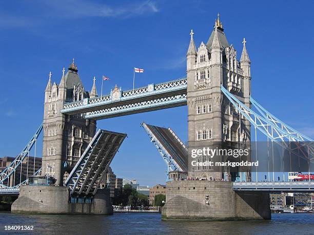 a picture of the tower bridge rising - tower bridge day stock pictures, royalty-free photos & images