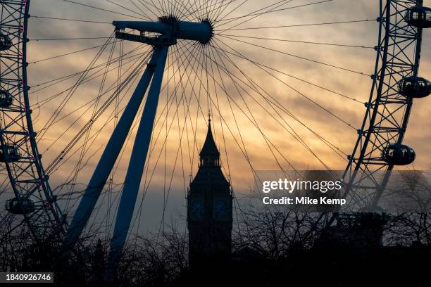 London Eye and the top of Houses of Parliament clock tower Big Ben in silhouette on on 6th December 2023 in London, United Kingdom. The...