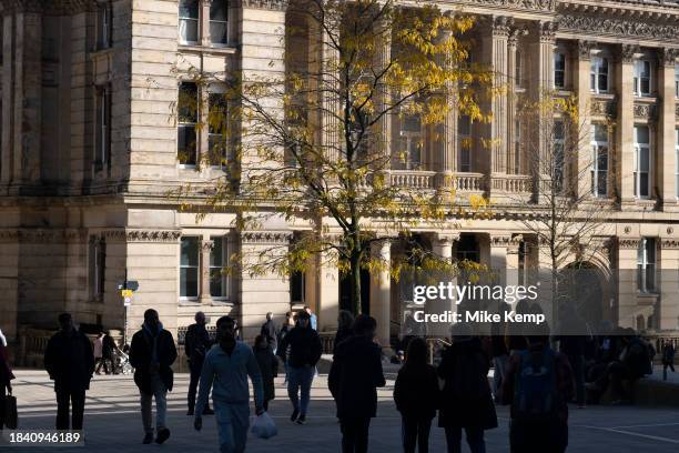 Silhouettes of people walking past the Birmingham City Council Town Hall building in Chamberlain Square in the city centre on 3rd November 2023 in...