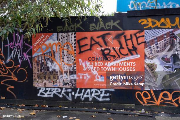 Eat the rich graffiti in protest over an advertisement for new town houses and apartments in the city centre on 9th November 2023 in Birmingham,...