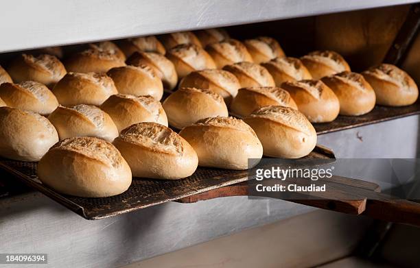 putting buns in oven - patisserie stock pictures, royalty-free photos & images