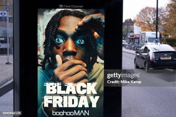 Signs for Black Friday sales for Boohoo Man on a bus stop advert in Mile End on 17th November 2023 in London, United Kingdom. Black Friday...