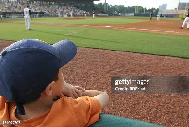 little boy at baseball game dreams concept - baseball fans stock pictures, royalty-free photos & images