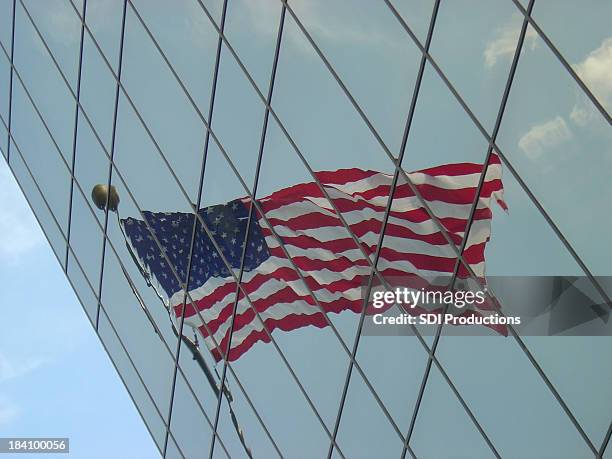 flag reflecting in an angled office building - indiana flag stock pictures, royalty-free photos & images