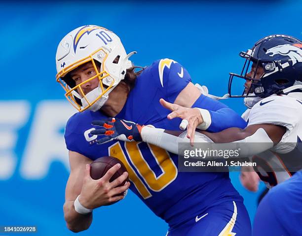 Inglewood, CA Chargers quarterback Justin Herbert is sacked by Broncos cornerback Ja'Quan McMillian in the first half, where he was sacked and...