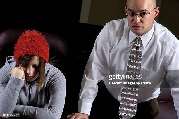 sulking girl with red hat sitting near man in business suit - legal defense stock pictures, royalty-free photos & images