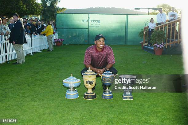 Tiger Woods poses with all four World Golf Championship trophies which he has now won with his victory at the Accenture Match Play Championship on...