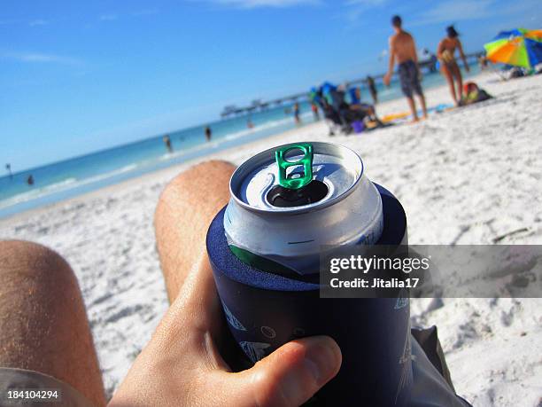 mann trinkt ein können bier am strand - kühlbehälter stock-fotos und bilder