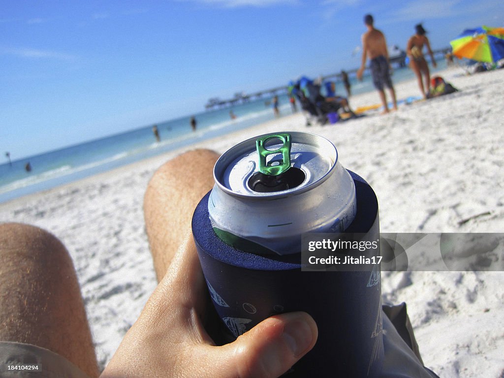 Man Drinking a Can of Beer at the Beach