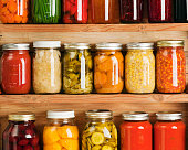 Home Canning Fruit and Vegetable Food Preserves in Storage Shelves