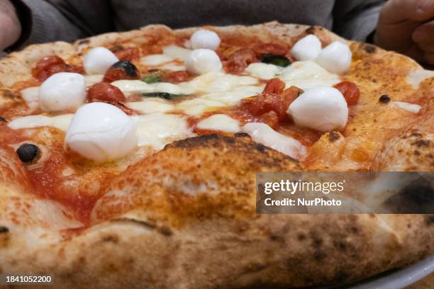 Margherita Pizza with small buffalo mozzarella is seen in Naples, Italy, on December 6th, 2023. Margherita pizza is a traditional Italian pizza,...