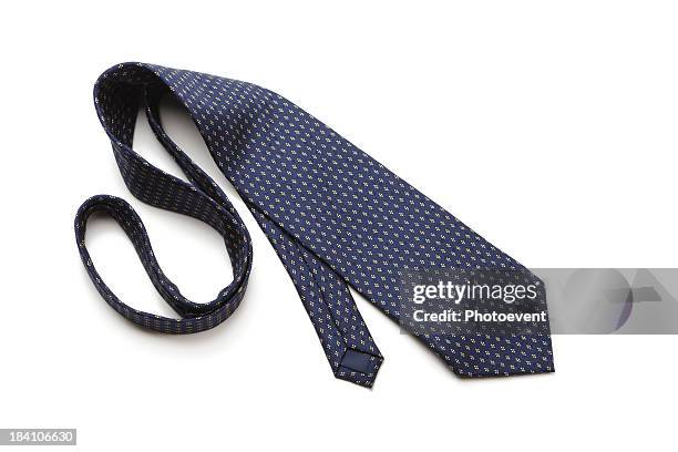 blue patterned necktie laying on white background - neckwear stock pictures, royalty-free photos & images