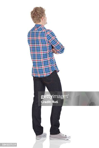 rear view of a man standing with arms crossed - look back stock pictures, royalty-free photos & images