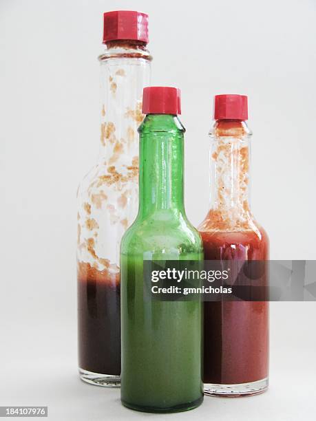 three different types of hot sauces - hot sauce stock pictures, royalty-free photos & images