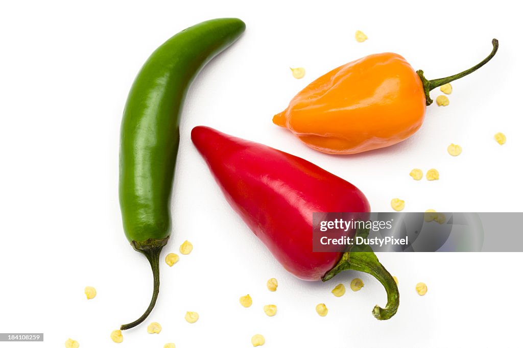Three different colored and shaped peppers isolated on white