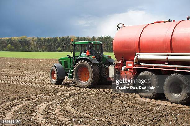 manure tank with tractor - fertilizer stock pictures, royalty-free photos & images