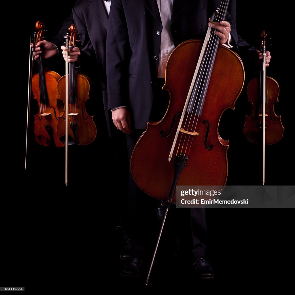 Quartet of string instrument musicians on a black background