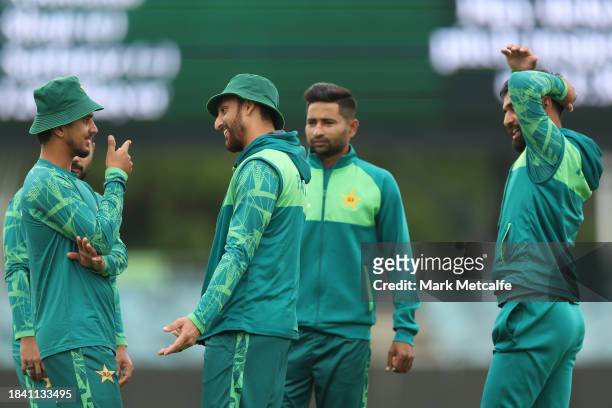 Pakistan players stand around during a delay to the start of play due to an overnight storm during day four of the Tour match between PMs XI and...