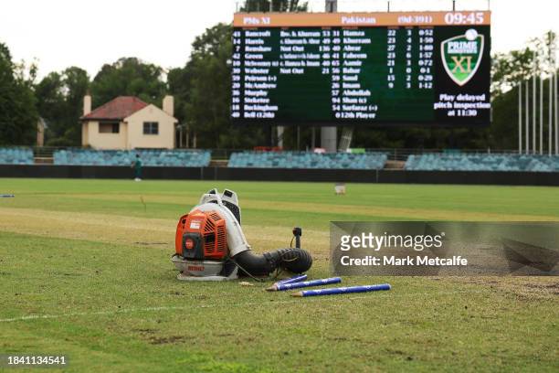 Blowers attempt to dry the wicket during a delay to the start of play due to an overnight storm during day four of the Tour match between PMs XI and...