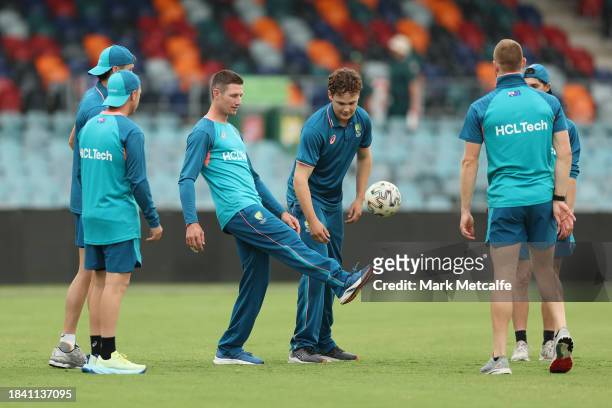Cameron Bancroft of the Prime Ministers XI kicks a football during a delay to the start of play due to an overnight storm during day four of the Tour...