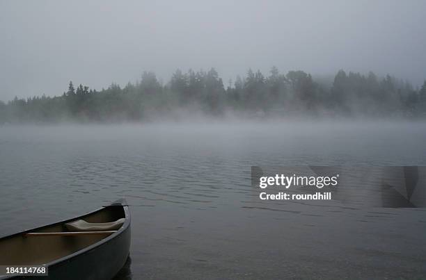 canoe on a foggy lake - fishers indiana stock pictures, royalty-free photos & images
