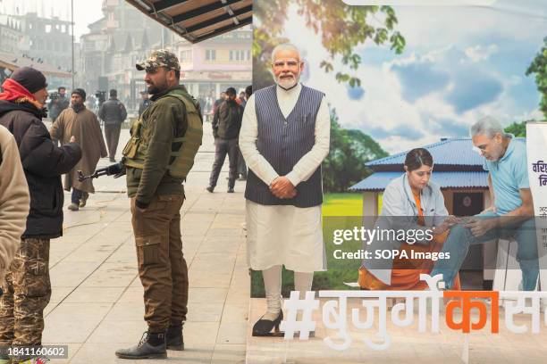 Indian policeman stands guard along a road in Srinagar ahead of Supreme Court's verdict on Article 370. India's top court on Monday upheld the...