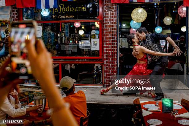 Tango dancers are seen dancing in La Boca.