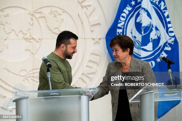 Ukrainian President Volodymyr Zelensky shakes hands with International Monetary Fund Director Kristalina Georgieva following talks at IMF...