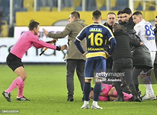 Referee Halil Umut Meler falls to the ground after Faruk Koca, President of MKE Ankaragucu throws a punch to him following the Turkish Super Lig week...