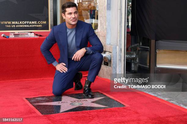 Actor Zac Efron poses by his newly unveiled star during his Hollywood Walk of Fame ceremony in Hollywood, California, December 11, 2023.