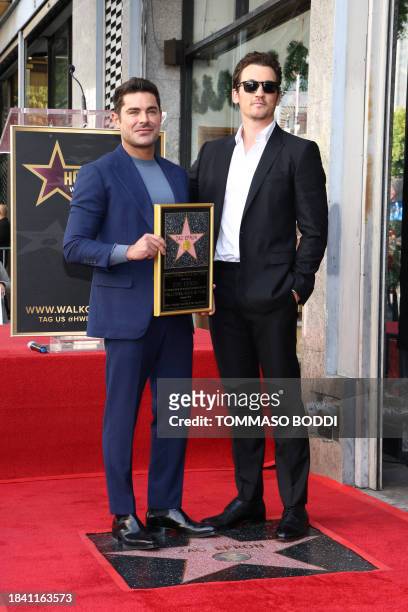 Actor Zac Efron poses with Miles Teller during his Hollywood Walk of Fame ceremony in Hollywood, California, December 11, 2023.