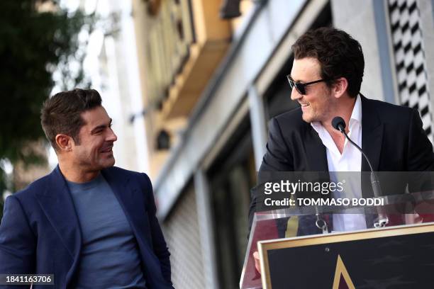 Actor Zac Efron looks on as Miles Teller speaks during his Hollywood Walk of Fame ceremony in Hollywood, California, December 11, 2023.