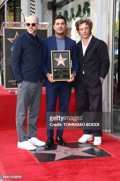 Actor Zac Efron poses with Sean Durkin and Jeremy Allen White during his Hollywood Walk of Fame ceremony in Hollywood, California, December 11, 2023.