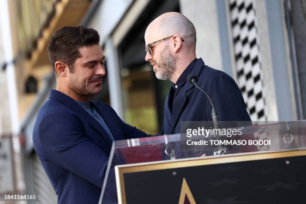Zac Efron and Sean Durkin embrace during the ceremony honoring Efron with a Star on the Hollywood Walk of Fame on December 11, 2023 in Hollywood,...