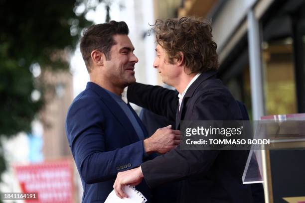 Zac Efron and Jeremy Allen White embrace during the ceremony honoring Efron with a Star on the Hollywood Walk of Fame on December 11, 2023 in...