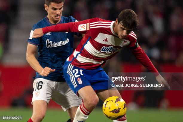 Athletic Bilbao's Spanish midfielder Inigo Ruiz de Galarreta vies with Granada's Spanish midfielder Gonzalo Villar during the Spanish league football...