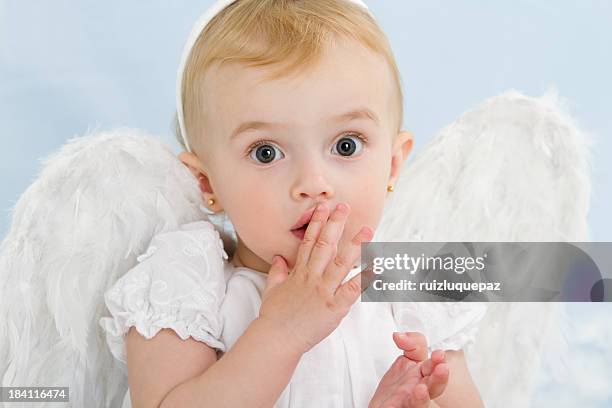 surprised little angel - angel white dress stock pictures, royalty-free photos & images