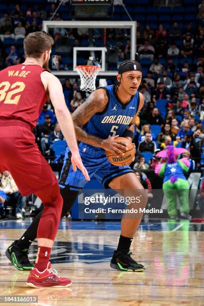 Paolo Banchero of the Orlando Magic looks to pass the ball during the game against the Cleveland Cavaliers on December 11, 2023 at Amway Center in...