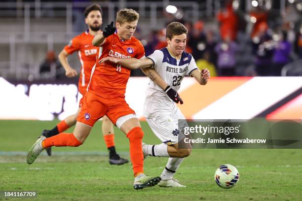 Brandon Parrish of the Clemson Tigers and Nolan Spicer of the Notre Dame Fighting Irish battle for the ball during the Division I Men's Soccer...