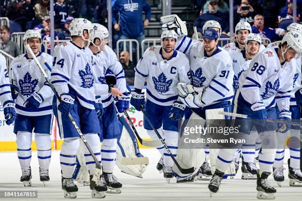 John Tavares of the Toronto Maple Leafs is congratulated by his teammates after scoring 1000 career NHL point on an assist on a goal by Morgan Rielly...